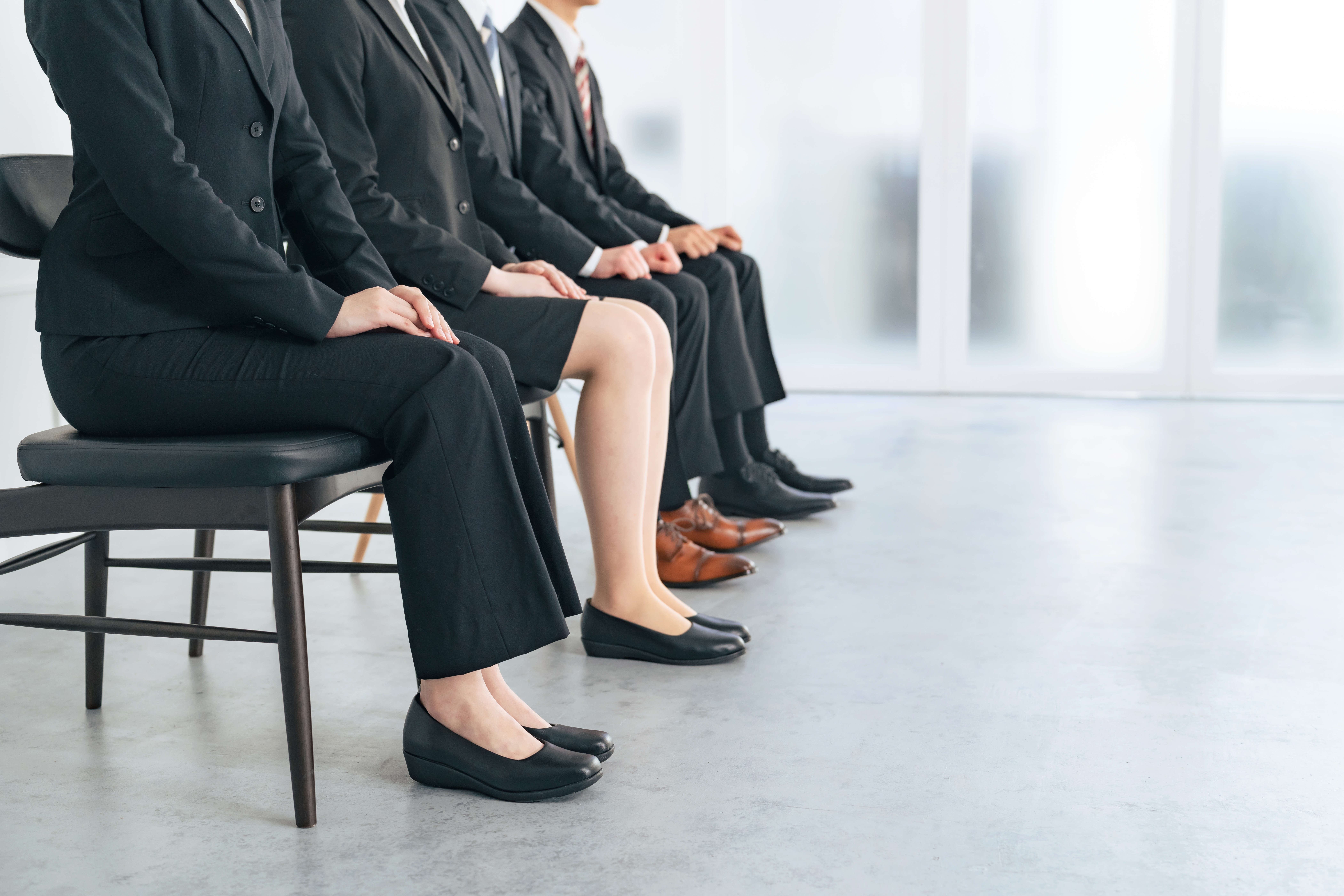 group of men and women lining up for a job interview